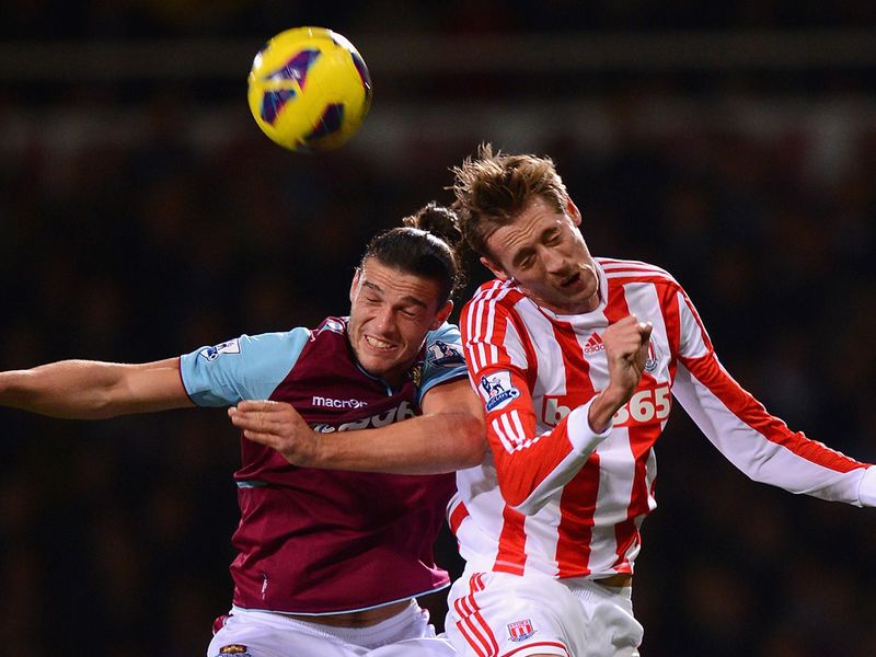 Andy Carroll and Peter Crouch compete in the air.