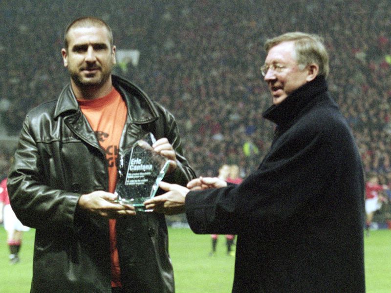 Cantona receives the 'Best Ever United Player' award from Sir Alex in 2001 at Old Trafford.
