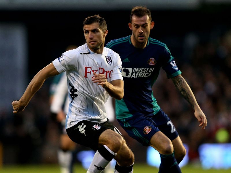 Aaron Hughes and Steven Fletcher vie for the ball in the early stages at Craven Cottage.