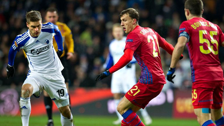 Rurik Gislason and Vlad Chiriches battle for the ball