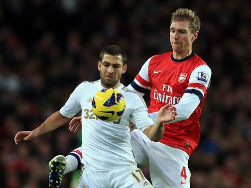 Itay Shechter holds off Per Mertesacker