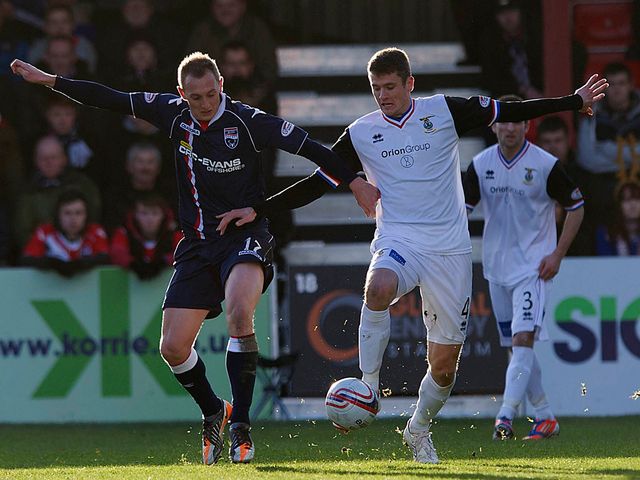 Sam Morrow and Owain Tudur Jones battle for the ball