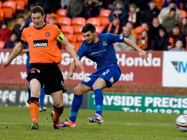 Daly and Graeme Shinnie battle for the ball