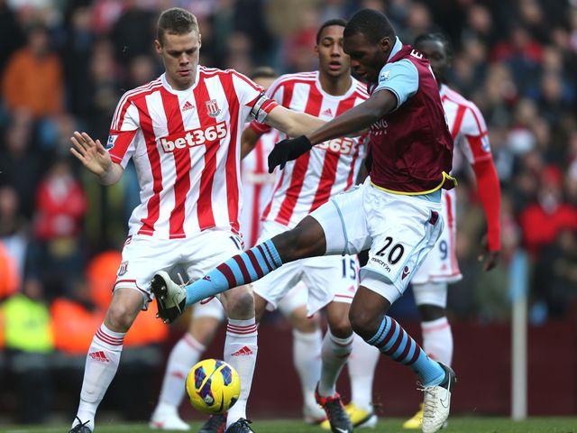 Ryan Shawcross competes with Christian Benteke