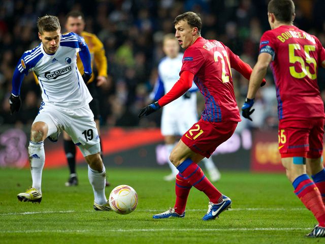 Rurik Gislason and Vlad Chiriches battle for the ball