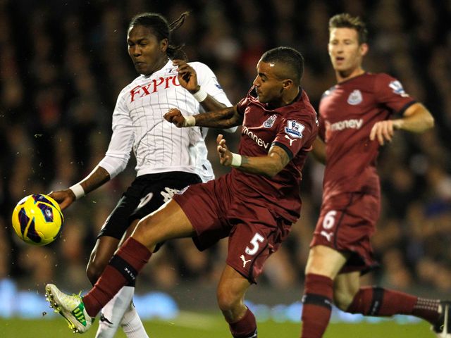 Hugo Rodallega is challenged by Danny Simpson