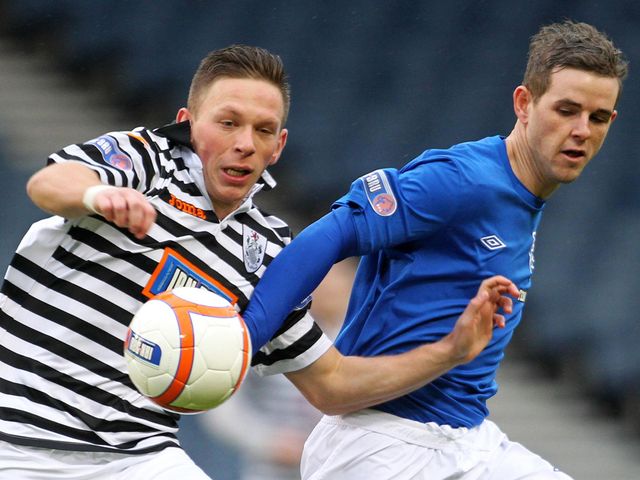 Michael Keenan and David Templeton vie for the ball