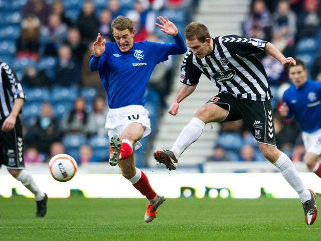 Nicolson knocks the ball away from Shiels.