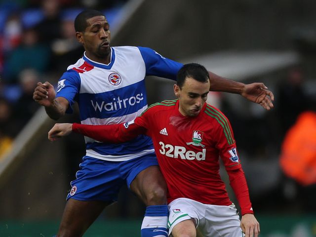 Leon Britton holds off Mikele Leigertwood