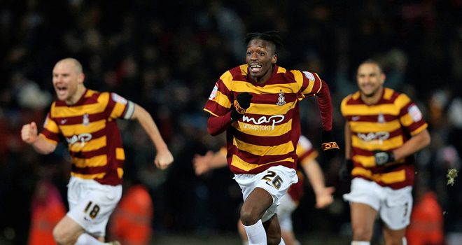 Bradford's players celebrate knocking Arsenal out at the quarter-final stage on penalties
