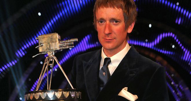Bradley Wiggins collects the famous trophy