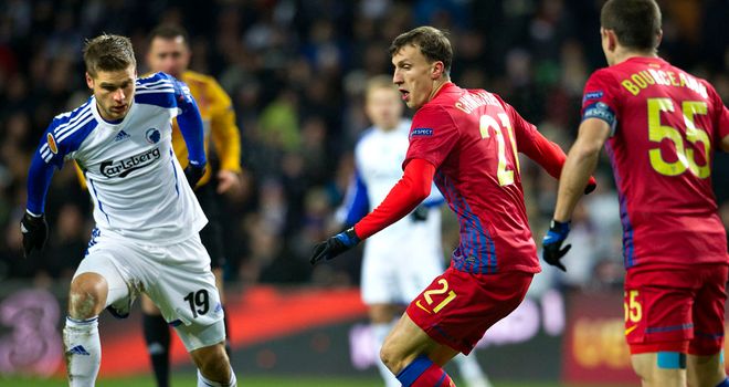Rurik Gislason and Vlad Chiriches battle for the ball