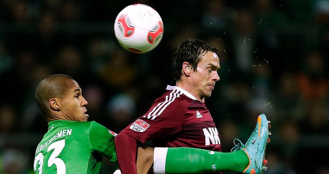 Gebre Seassie and Feulner challenge for the ball.