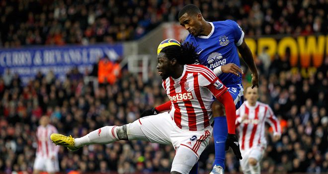Everton defender Sylvain Distin does battle with Stoke's Kenwyne Jones