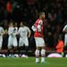 Theo Walcott's disappointment is clear to see as Swansea celebrated during a 2-0 victory at Arsenal