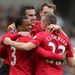 ...before being mobbed by delighted team-mates
