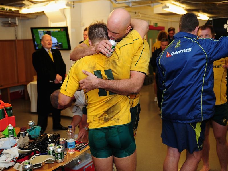 ...while Sharpe embraces Mitchell after the game...