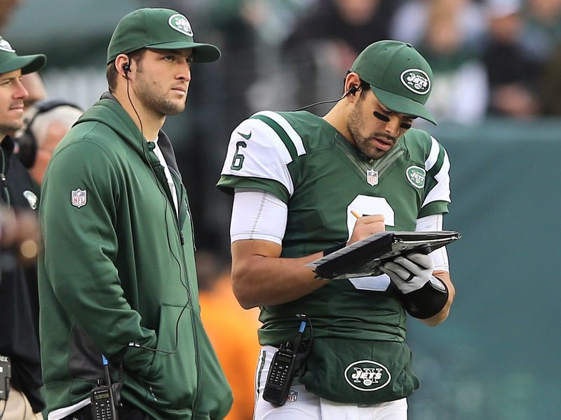 Mark Sanchez (right, next to an injured Tim Tebow) threw three interceptions and was benched during the NY Jets' 7-6 win over Arizona