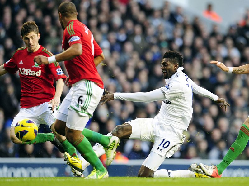 Tottenham striker Emmanuel Adebayor tries his luck from distance against Swansea City