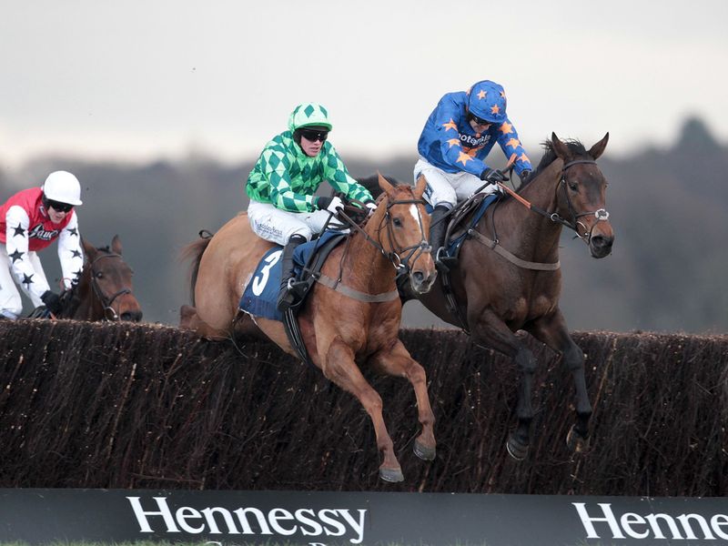 Merry King leads Rolling Aces in the novices' handicap chase...