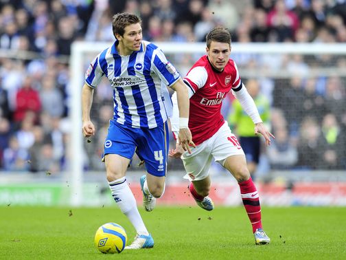 Dean Hammond and Aaron Ramsey battle for the ball