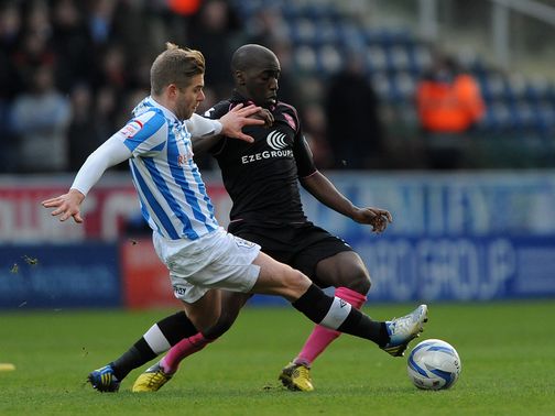 Clayton and Gomis battle for the ball