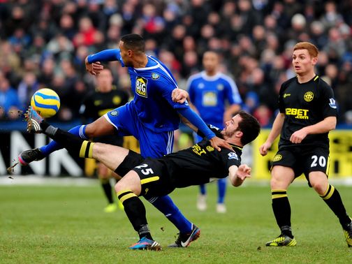 Matthew Barnes-Homer and Roman Golobart tussle for the ball
