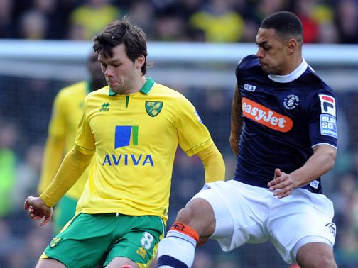 Jonny Howson is challenged by Andre Gray