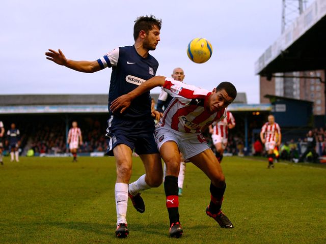 Mark Phillips and Tom Adeyemi battle for the ball