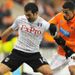Fulham's Giorgos Karagounis fends away the attentions of striker Nathan Ecclestone