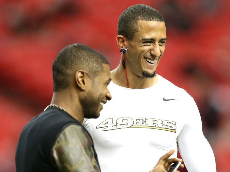 Colin Kaepernick chats with Usher before the game