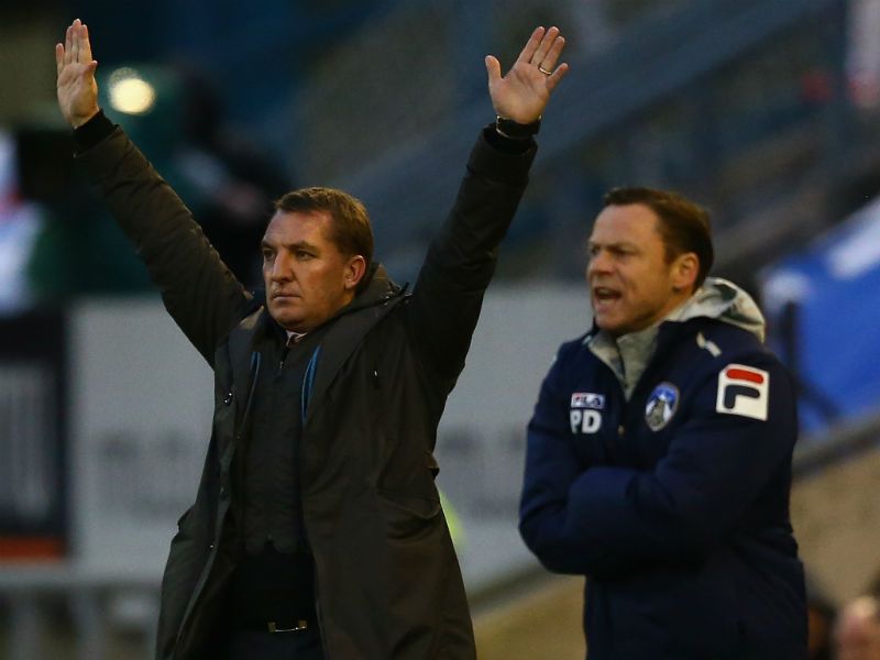 Shouting orders: Liverpool boss Brendan Rodgers and Oldham manager Paul Dickov rally their troops at Boundary Park