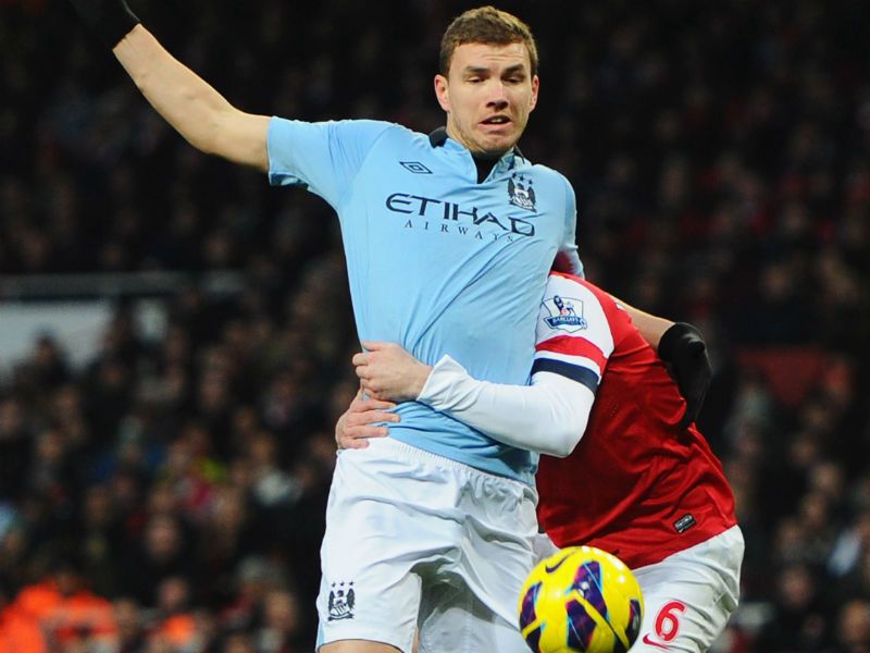 Penalty given: Edin Dzeko is fouled in the box by Laurent Koscielny, who gets sent off and City are awarded a penalty