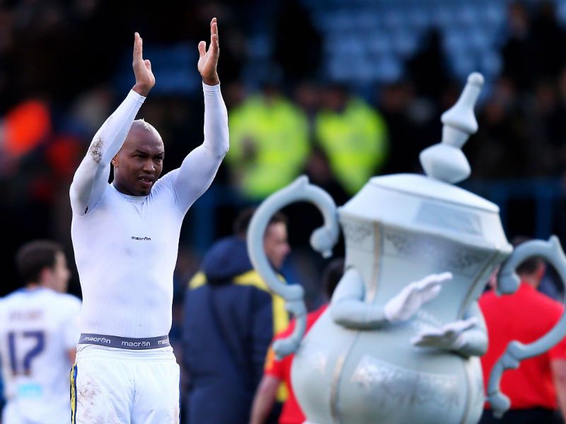 Leeds through: El-Hadji Diouf applauds the fans following his team's 2-1 victory over Spurs