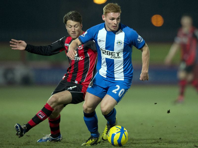 Bournemouth's Harry Arter keeps a close eye on Wigan midfielder Fraser Fyvie