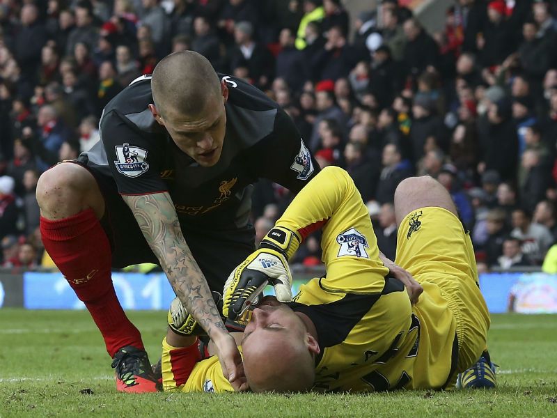 Courageous keeper: Pepe Reina of Liverpool lies injured on the pitch after a collision with Shinji Kagawa