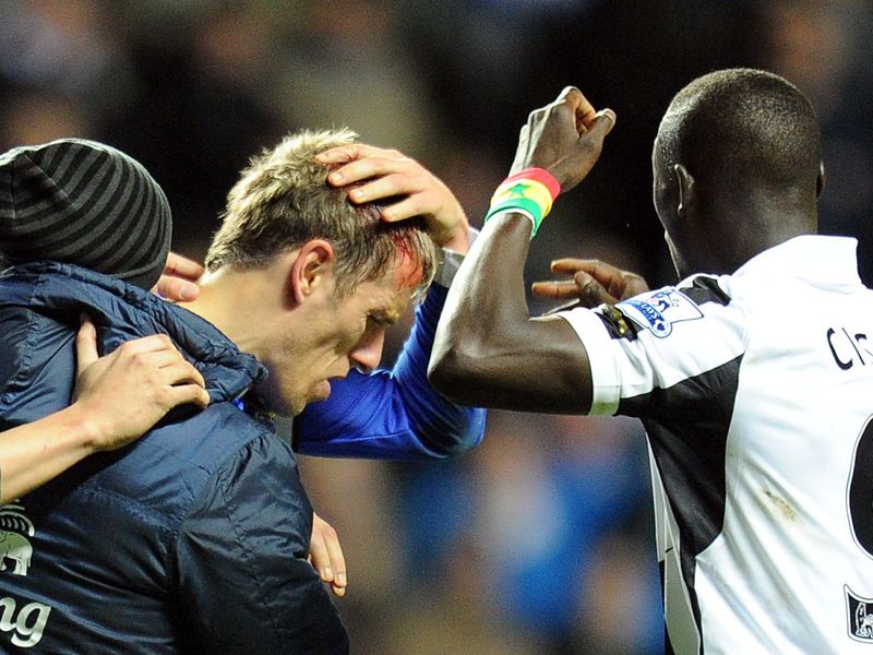 Phil Neville takes a sore one in the closing stages