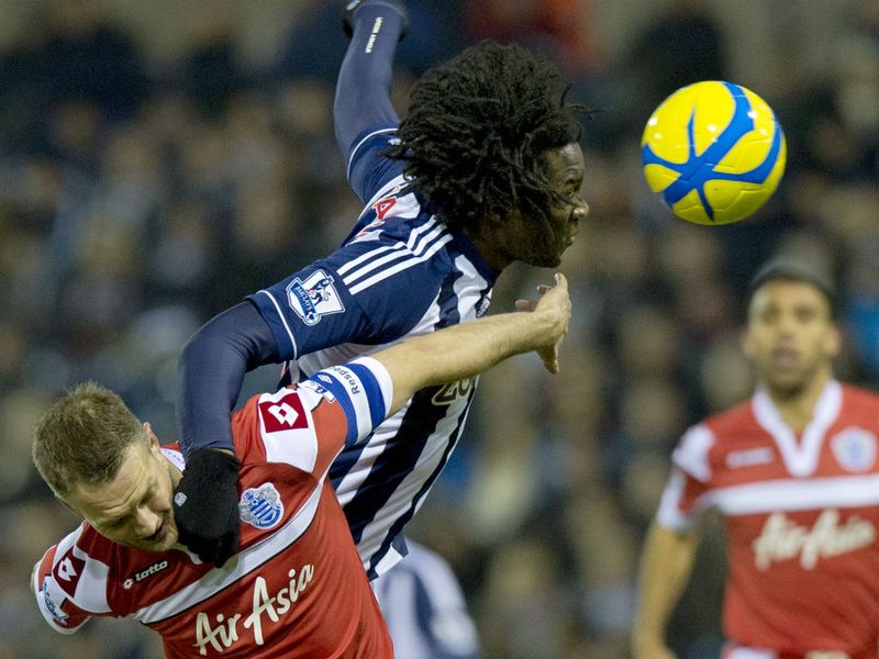 Belgian forward Romelu Lukaku gets above QPR defender Clint Hill to win the ball