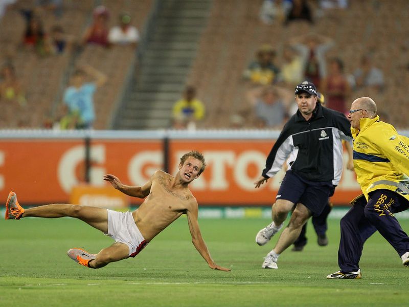 A pitch invader ran on and bowled a tennis ball down the track before being chased off.