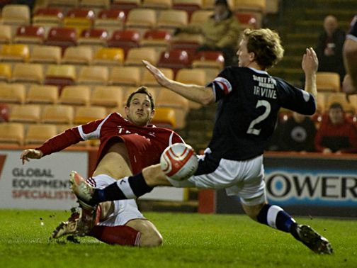 Scott Vernon is closed down by Gary Irvine.