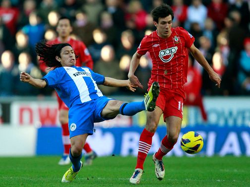 Roger Espinoza challenges Jack Cork.