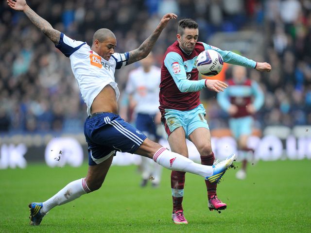 Zat Knight and Danny Ings battle for possession at the Reebok