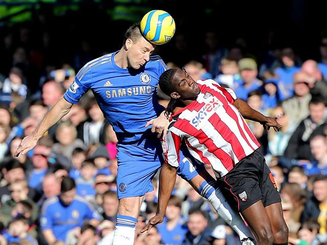 John Terry wins a header.