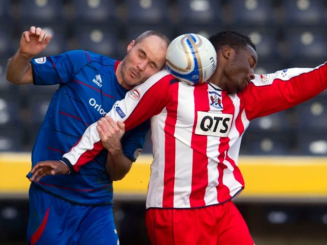 David Raven and William Gros go up for a header.