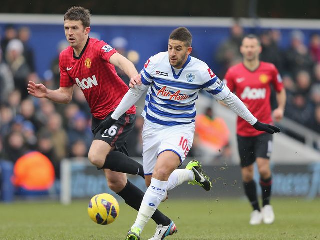 Adel Taarabt and Michael Carrick battle for the ball