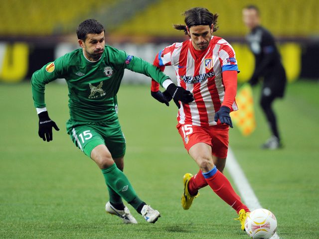 Sergei Kislyak vies with Atletico Madrid's Domingo Cisma