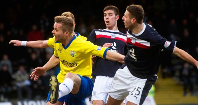 Dundee's Lewis Toshney (far right) scores against Morton