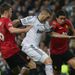 Manchester United pair Michael Carrick and Rafael try to halt Real Madrid striker Karim Benzema