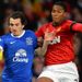 Everton left-back Leighton Baines battles for the ball with United winger Antonio Valencia.