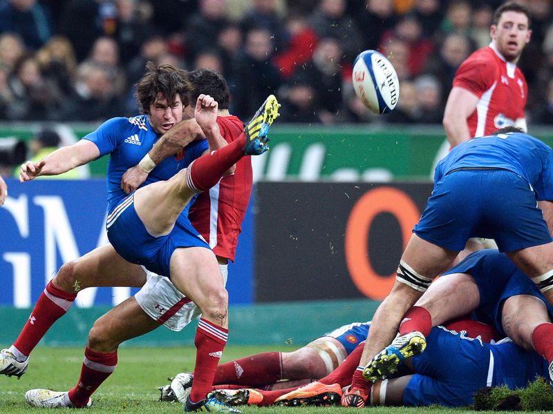 Under pressure: Maxime Machenaud has to rush a clearance as Dan Biggar charges in